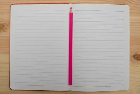 Notebook and red pencil. Stock Photos