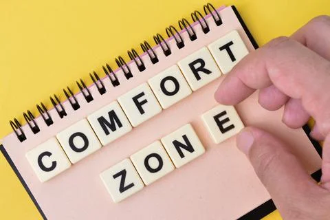 Notebook and scrabble letters with text COMFORT ZONE. Stock Photos