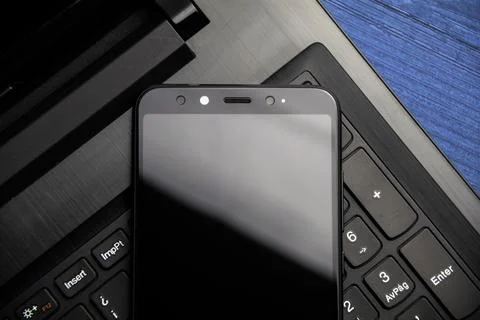 Notebook and smartphone copy space. Modern mobile with camera. Top view. Stock Photos