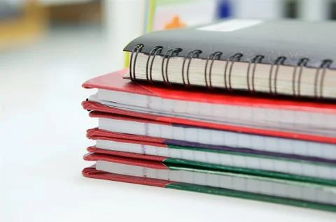 Notebook and stack of report book at office Foto stock
