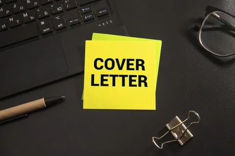 Notebook and a white sheet of paper with the text COVER LETTER Stock Photos
