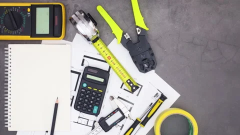 Notebook appear on table with construction tools and plans. Stop motion Stock Footage 136914253