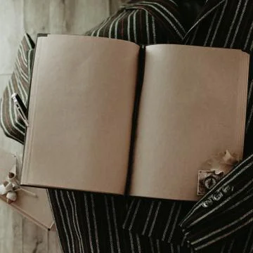 Notebook in autumn composition on the striped jacket. Stock Photos
