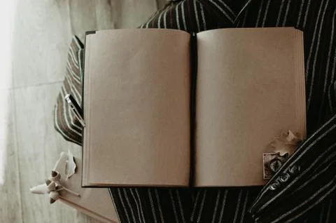 Notebook in autumn composition on the striped jacket. Stock Photos