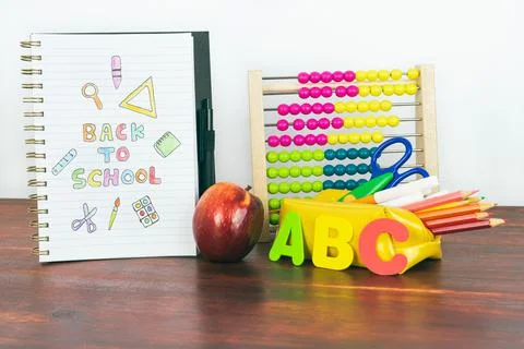 Notebook with back to school drawing. Abacus, pencils, letters and an apple. Foto stock