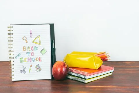 Notebook with back-to-school drawing. Apple and study notebooks. Stock Photos