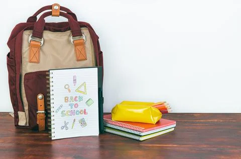 Notebook with back to school drawing. Backpack and school supplies. Stock Photos