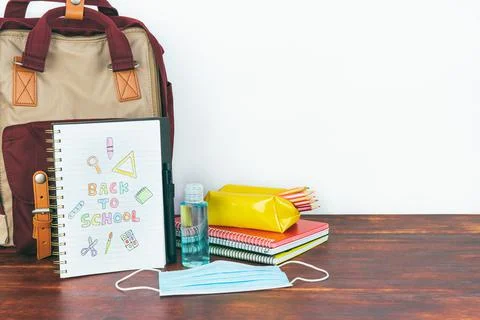 Notebook with back to school drawing. Backpack and school supplies. Stock Photos