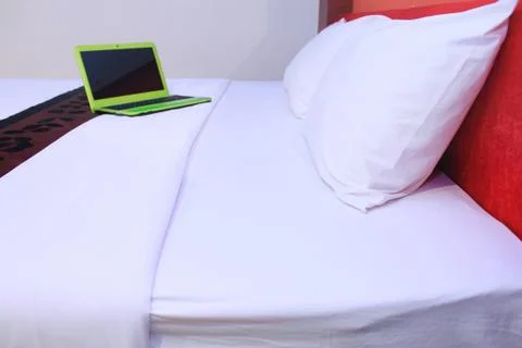 Notebook on a bed in a hotel Stock Photos