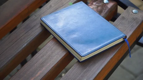 Notebook on bench in park, business concept Stock Footage 93342903