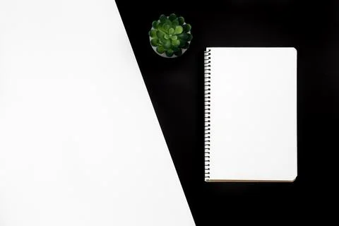 A notebook on a black and white background, minimal flat lay. Stock Photos