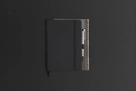 Notebook on black leather background. Flat lay composition. Top view. Fotos de archivo