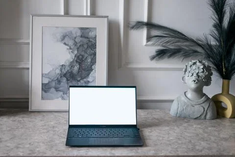 Notebook with blank screen on table in living room. Stock Photos