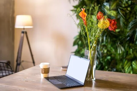 Notebook with blank screen on table in living room. Stock Photos