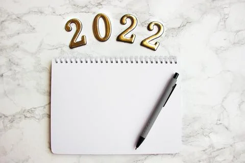 Notebook with a blank sheet, a pen for writing plans for 2022 Stock Photos