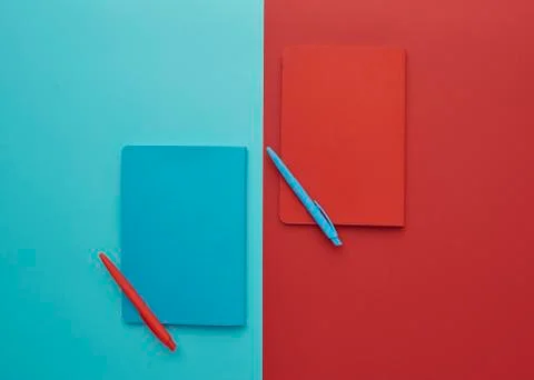 Notebook on a blue and red background Stock Photos
