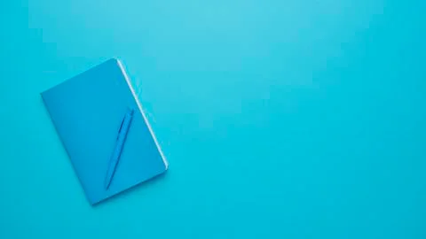 Notebook on a blue background Stock Photos