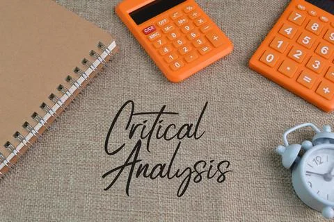 Notebook, calculator and and clock with text CRITICAL ANALYSIS Stock Photos