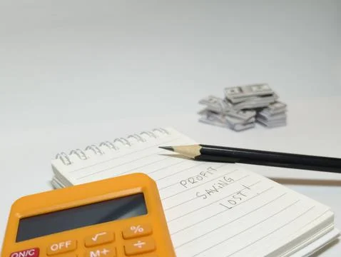 Notebook, Calculator, Pencil and Cash Stack For Financial Planning and Budgeting Stock Photos