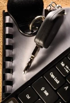 Notebook, car key and computer keyboard 스톡 사진
