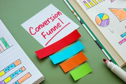 Notebook with charts and conversion funnel. Marketing and optimization concep Stock Photos