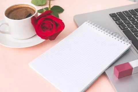 Notebook with a clean sheet, a Cup of black coffee, scarlet rose flower, pink Stock Photos