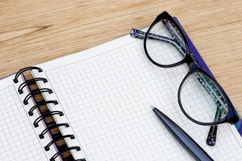 Notebook with clean white sheets with a pen and glasses Stock Photos