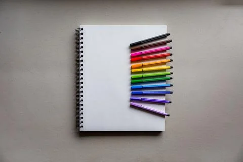 Notebook with colorful art supplies Stock Photos