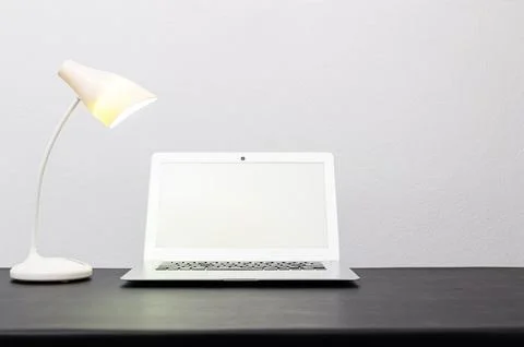 Notebook computers and lamps On the desk at the office Stock Photos