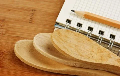 Notebook for culinary recipes on a kitchen cutting board Stock Photos