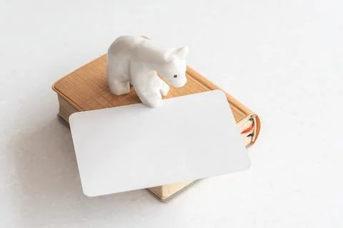 Notebook with decorative bear figure and blank business card Stock Photos