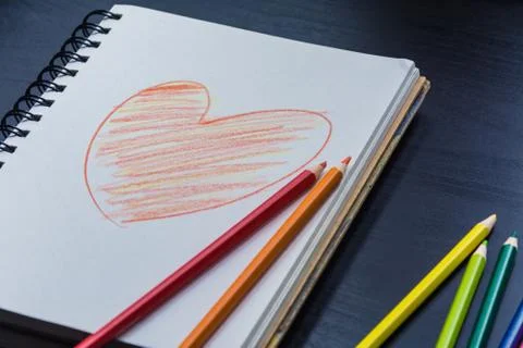 Notebook on the desk , Heart drawing on the notebook Stock Photos