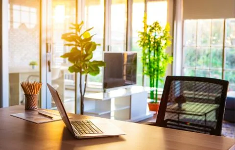 Notebook on desk in sunlight. Stock Photos