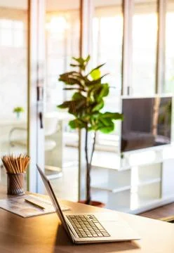 Notebook on desk in sunlight. Stock Photos