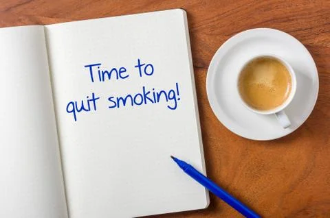 Notebook on a desk - time to quit smoking Stock Photos