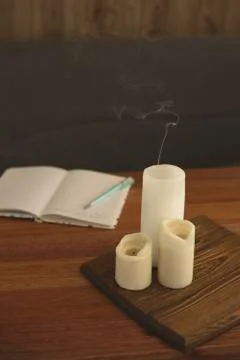 Notebook for diary entries on the table with candles. Stock Photos