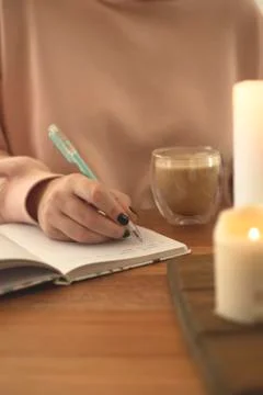 Notebook for diary entries on the table with candles. Stock Photos
