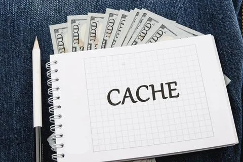 Notebook displaying the word cache alongside a fan of dollar bills, illustrat Stock Photos