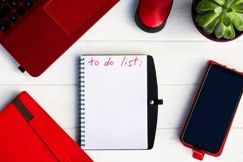 Notebook with To Do List with phone, red diary and laptop on a white wooden b Stock Photos