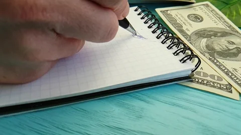 Notebook dollars, hand writes, slow-motion office Stock Footage 88141269