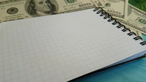 Notebook dollars, pen falls, slow-motion office Stock Footage 88141241