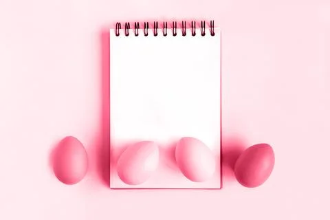 Notebook with Easter Eggs. Spiral notepad on spring white background. Top v.. Stock Photos