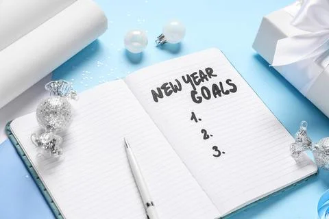 Notebook with empty to do list and Christmas decor on light blue background Stock Photos