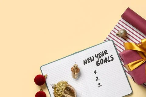 Notebook with empty to do list, Christmas decor on light yellow background Stock Photos