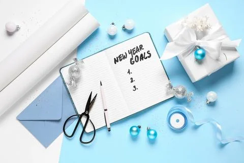 Notebook with empty to do list, Christmas gift and decor on light blue backgr Stock Photos