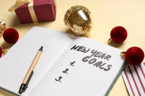 Notebook with empty to do list, Christmas decor on light yellow background Stock Photos