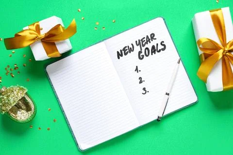 Notebook with empty to do list for new year and Christmas gifts on green back Stock Photos