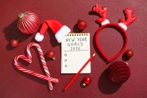 Notebook with empty to do list, pencil and Christmas decor on dark red grunge Stock Photos