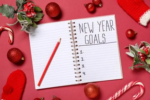 Notebook with empty to do list, pencil and Christmas decor on red background. Stock Photos