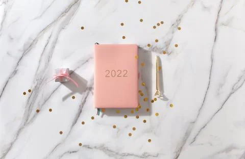 Notebook with empty pages for text, with pen, coffee cup, gift boxes, gold Stock Photos